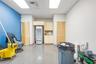 Interior space featuring light wood-finish cabinetry, louvered closet doors, and a smooth-finish floor