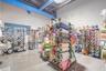 Industrial space featuring high, exposed ceilings with blue-finished ductwork and polished concrete flooring