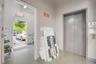 Elevator access featuring painted metal sliding doors and a dedicated exterior doorway