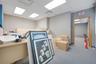 Interior space featuring light-toned built-in cabinetry, grey carpeted flooring, and recessed ceiling lighting