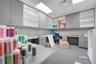 Built-in gray cabinetry with expansive counter surfaces, open shelving, and integrated drawer storage