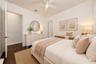 Virtually staged. Wood-finish flooring, ceiling fan with integrated lighting, and neutral wall tones