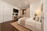 Virtually staged. Built-in light-tone wood cabinetry with integrated desk space, wood-finish flooring, and recessed ceiling lighting
