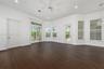 Wood-finish flooring, multi-pane windows with horizontal blinds, sliding glass door, recessed lighting, and ceiling fan