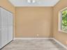 Tile flooring with a stone-finish pattern, bi-fold closet doors, and a ceiling-mounted light fixture