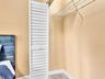 Closet featuring white louvered doors and wire shelving