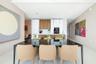 Kitchen featuring floor-to-ceiling cabinetry, wood-finish accents, a peninsula with stone countertop, and built-in appliances
