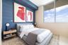 Textured blue accent wall with large-format, floor-to-ceiling windows