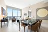 Open-concept living space featuring floor-to-ceiling windows, porcelain tile flooring, and a private balcony