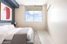Floor-to-ceiling accent wall, large sliding window, and neutral tile flooring