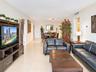 Open-concept interior featuring large-format tile flooring and neutral wall finishes