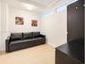 Wood-finish flooring, high-level transom windows, flush-mount ceiling lighting, and built-in dark cabinetry