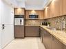 Kitchen featuring dual-toned flat-panel cabinetry, light-toned stone countertops, a mosaic tile backsplash, stainless steel appliances, and tile floor