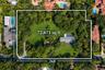 Expansive 72,671 square foot lot featuring a private swimming pool, mature trees, manicured lawn, and a circular driveway