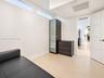 Interior space featuring clerestory windows, neutral tile flooring, and a multi-panel interior door
