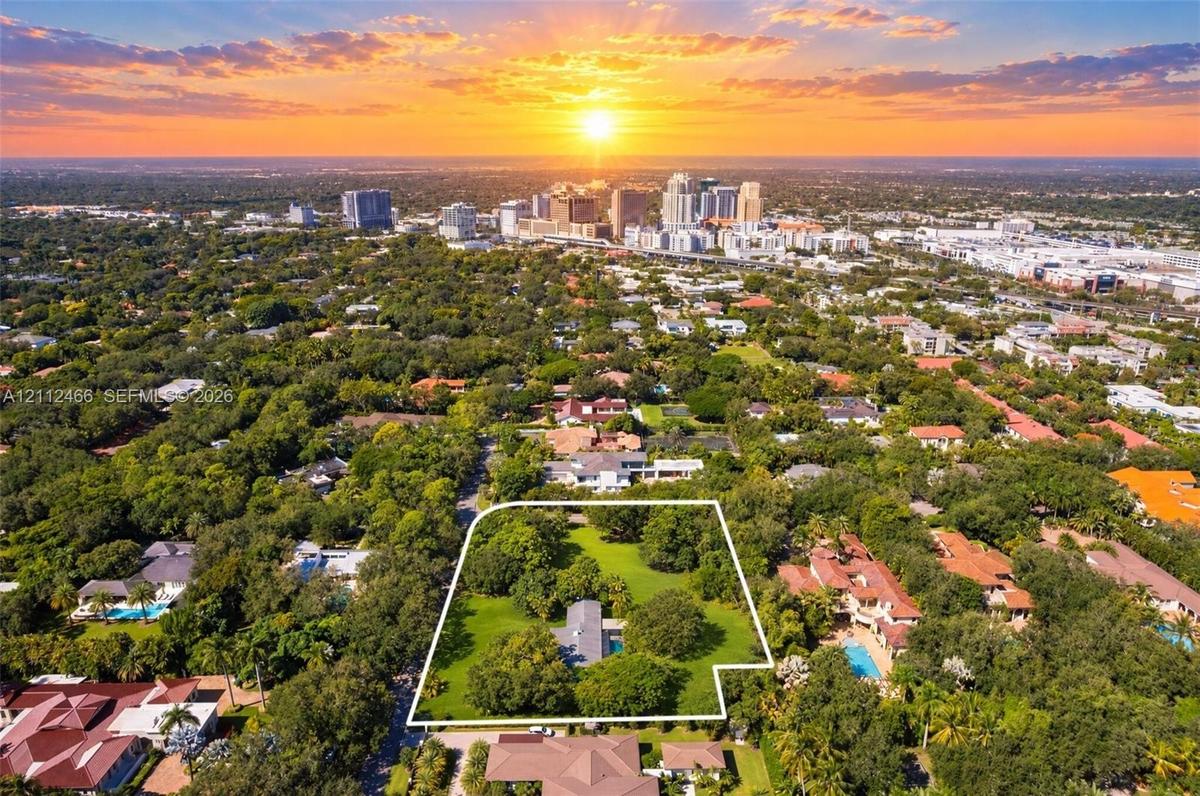 Expansive lot with mature canopy trees, lush landscaping, and defined property boundaries