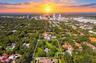 Expansive lot with mature canopy trees, lush landscaping, and defined property boundaries