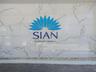 Polished large-format stone wall cladding with high-contrast veining, featuring a decorative building signage element and a base layer of smooth decor