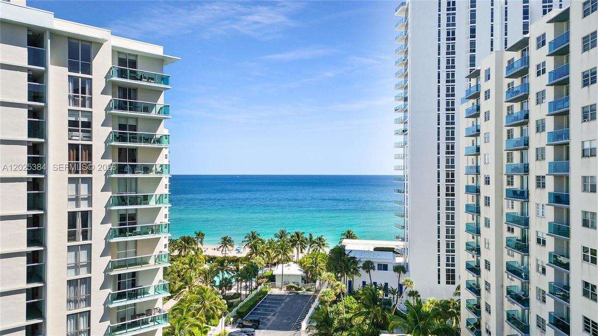 High-rise exterior featuring stacked balconies with glass railings and unobstructed ocean frontage