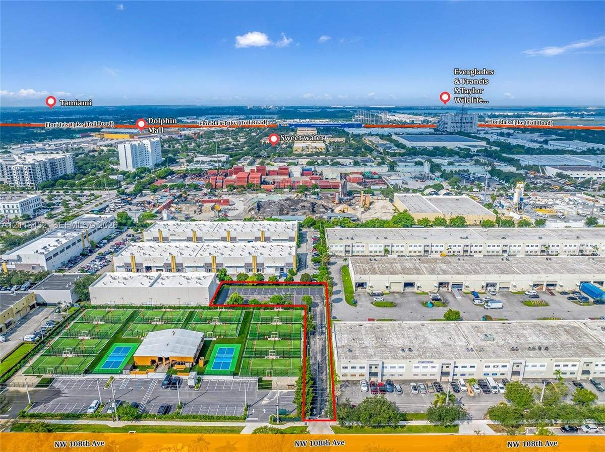 Aerial perspective of the commercial property featuring multiple dedicated asphalt parking