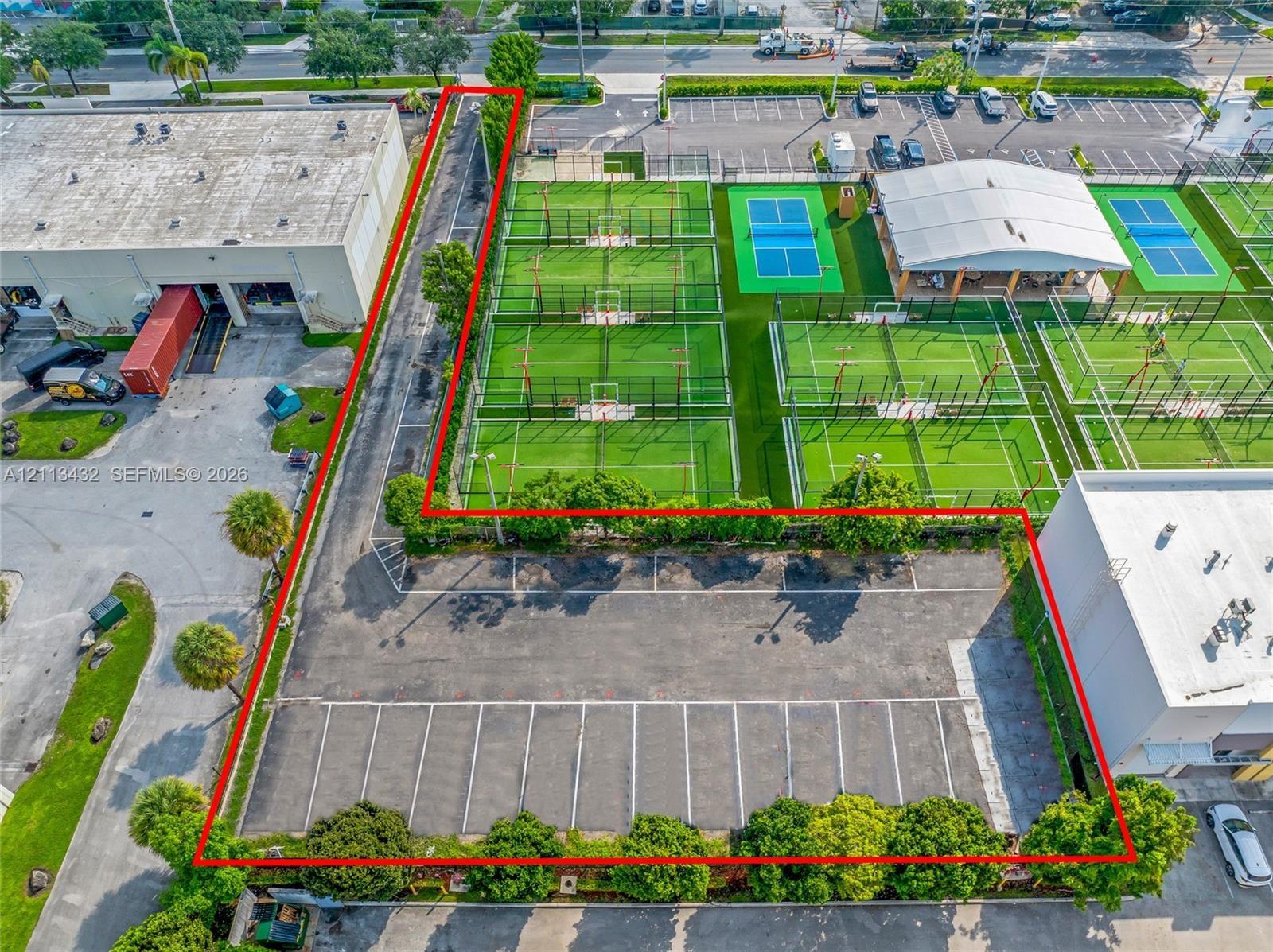 Commercial property featuring an asphalt parking lot with striped spaces.