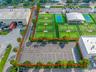 Commercial property featuring an asphalt parking lot with striped spaces.