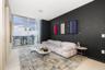 Floor-to-ceiling glass paneling featuring a metal frame and sliding glass door, providing a panoramic outlook, complemented by neutral tile flooring a
