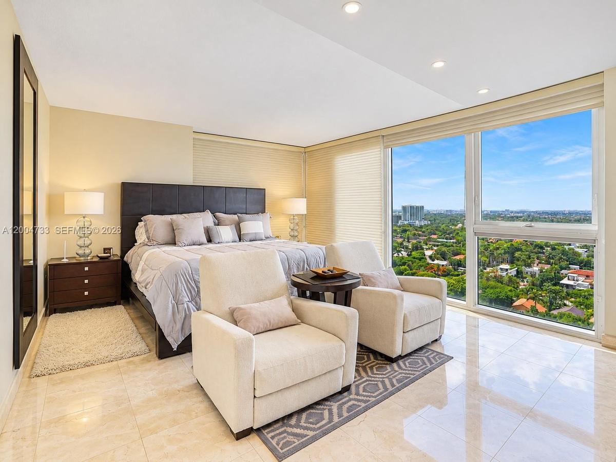 Floor-to-ceiling windows featuring panoramic exterior scenery, polished stone flooring, and recessed ceiling lighting