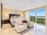 Floor-to-ceiling windows featuring panoramic exterior scenery, polished stone flooring, and recessed ceiling lighting