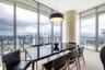Floor-to-ceiling glass walls, sleek tile flooring, structural cylindrical column, and dome pendant lighting