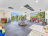Open-concept room featuring floor-to-ceiling windows, recessed lighting, and interlocking foam flooring
