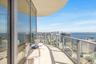 Curved balcony featuring floor-to-ceiling glass paneling and metal railings
