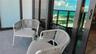 Private balcony featuring dark metal-framed glass railings and floor-to-ceiling sliding glass doors