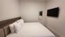 Neutral interior space featuring wood-finish flooring and wall-mounted electrical outlets