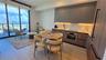 Contemporary kitchen featuring flat-panel two-tone cabinetry, stone-finish countertops with integrated backsplash, built-in wall oven and cooktop, woo