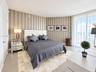 Neutral-toned striped wallpaper, floor-to-ceiling windows, and polished tile flooring