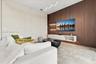Floor-to-ceiling fluted wood-finish accent wall with integrated shelving, large-format tile flooring, textured wall finish, and contemporary wave-form