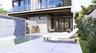 Outdoor living area featuring a swimming pool with a mosaic tile water feature, built-in outdoor kitchen, concrete patio, glass-panel railings, and sl