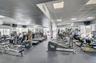 Fitness center featuring expansive floor space, wall-to-wall mirrors, recessed lighting, and rubberized athletic flooring