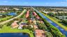 Aerial perspective of property featuring tile roofing, situated within a cul-de-sac and proximate to waterfront