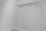 Storage space featuring white walls and a mounted wire shelving unit