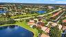Aerial perspective of a residential property featuring a tiled roof and a waterfront lot on a cul-de-sac