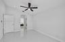 High-gloss tile flooring, vaulted ceilings, recessed lighting, arched entryway, and modern ceiling fan