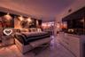 Polished stone flooring, floor-to-ceiling glass sliding doors, and recessed ceiling lighting