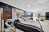 Textured charcoal feature wall with integrated recessed lighting, floor-to-ceiling glass sliding doors, and crown molding