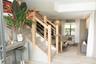 Staircase featuring light wood framing and horizontal steel tension cables, complemented by light wood-finish flooring and recessed ceiling lighting