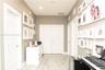 Hallway featuring light-toned wood-finish flooring, neutral wall paint, recessed lighting, and multiple white multi-panel doors