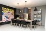 Large-format dining area featuring two suspended black pendant lights, light-toned stone-finish flooring, and a vertical wood-slat accent wall