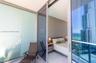 Private balcony featuring floor-to-ceiling glass paneling, tile flooring, and sliding glass door access