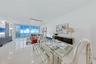 Open-concept interior featuring large-format tile flooring, recessed ceiling lighting, and floor-to-ceiling glass panel walls